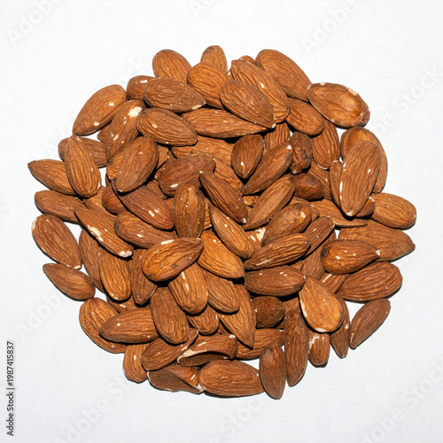 Almonds and peeled nuts.Almonds are edible seed kernels or the seeds of the plant of the same name from the Almond subgenus of the Plum genus.Almonds are common.