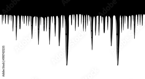 Black paint drips down on white background creating abstract texture and pattern