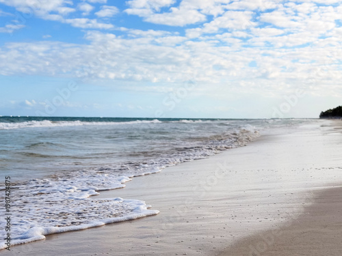 Beautiful wavy sea and sandy beach at tropical resort