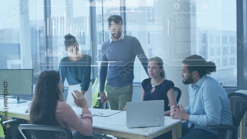 Five coworkers in business meeting, woman gesturing at laptop sparking HUD charts showing progress