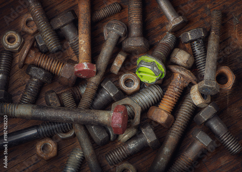 Various old nuts and bolts on an old workbench