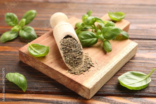 Dry basil and fresh leaves on wooden table, closeup