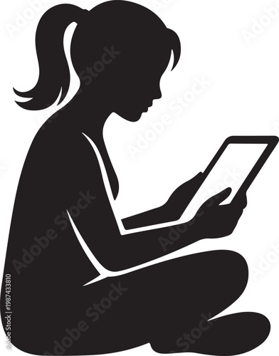 Silhouette of a young girl sitting cross-legged, engrossed in reading on a tablet device keywords