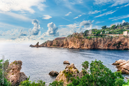 beautiful landscape of famous italiat resort Portofino in Luguria with ancient houses and buildings of hotels and restaulants along the embarkment of a sea gulf with sunset golden light