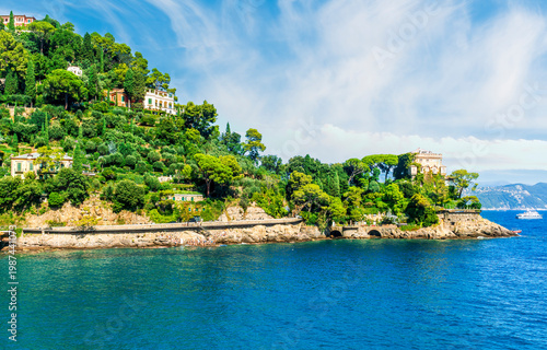 panoramic view of beautiful sea coast with amazing green hills nice antuque buildings and blue water in a sea bay. Ligurian gulf during day or evening.