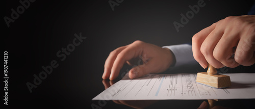 Businessman working in office with stamp