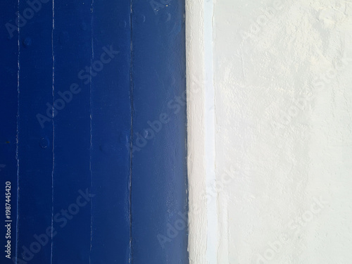Minimalist Abstract Background with Blue Wood Panels and Textured White Wall Contrast