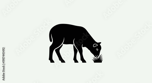 Black silhouette of a sheep grazing on grass simple and elegant design.