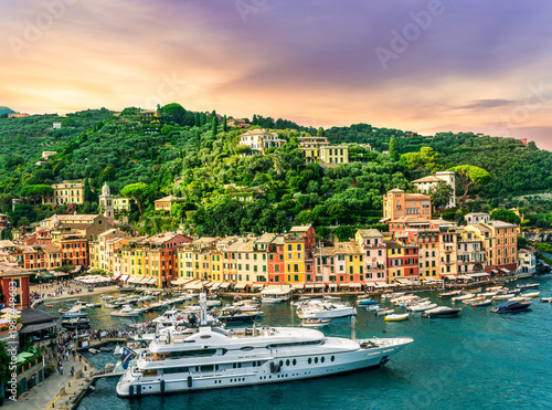beautiful landscape of luxury resort Portofino in Luguria , Italy.  Sea coast of elite italian resort during sunset or sunrise. Beautiful bay with buildings and green mountain forest.