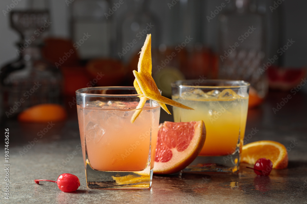Fototapeta premium Cocktails with ice, grapefruit juice, and orange juice garnished with maraschino cherry.