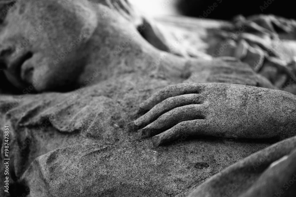 Fototapeta premium Resting angel statue in monochrome, symbol of peace, death and eternal rest.
