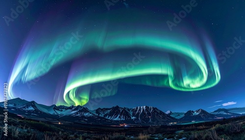 vibrant omega band aurora borealis swirling over snowy mountain landscape at night