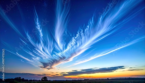 Dramatic blue twilight sky with radiant sunburst and rare noctilucent clouds at dusk