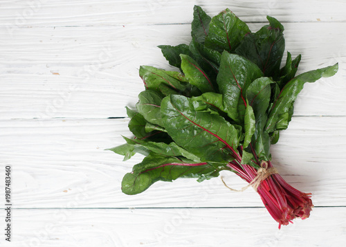 Fresh organic chard on a wooden background, Sweet beet leafs (mangold) . Selective focus