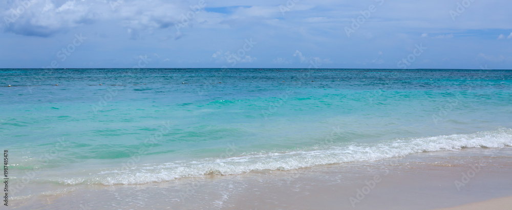 Obraz premium Caribbean Sea beach with white sand and clouds sky.