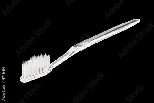 Transparent plastic toothbrush isolated on black background. Close-up