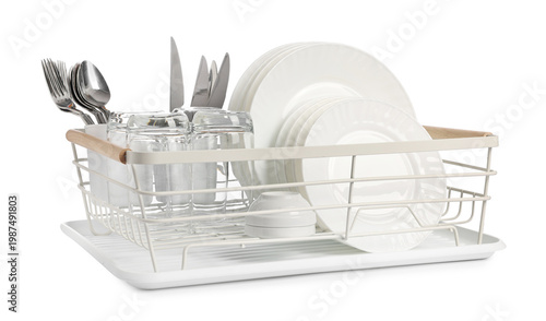 Foto Clean dishes, glasses and cutlery in drying rack on white background