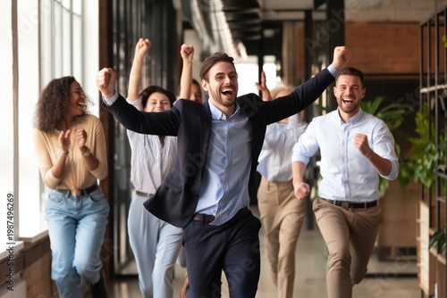 Team Celebrates Success While Running in Office Hallway During a Bright Day at Work