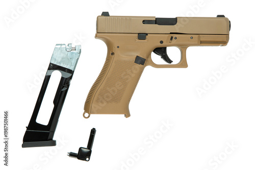 Desert tan pneumatic air pistol with magazine and tool on white back