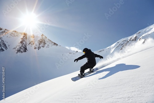 Snowboarder Glides Down Snowy Slope Under Bright Sun in Mountain Range