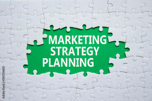 Marketing Strategy Planning symbol. White puzzle with words Marketing Strategy Planning. Beautiful deep background. Business concept. Copy space.