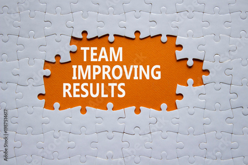Team Improving Results symbol. White puzzle with words Team Improving Results. Beautiful orange background. Business concept. Copy space.
