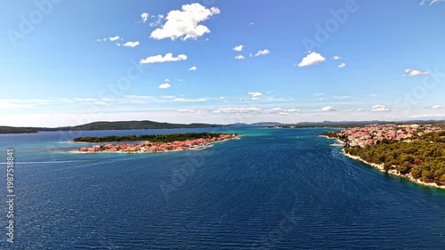 Aerial footage of Tisno town and Murter island in Croatia, beautiful Adriatic sea coastline with red roof houses and blue water