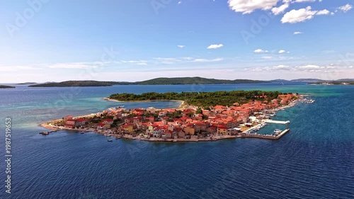 Aerial view of Krapanj island and the coastal town with red roofs in the Adriatic Sea, Sibenik archipelago, Croatia