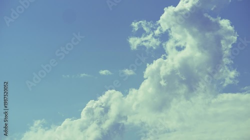 Cumulus clouds moves in the blue sky. The background of light and heavy calm clouds changes shape in cloudy space.