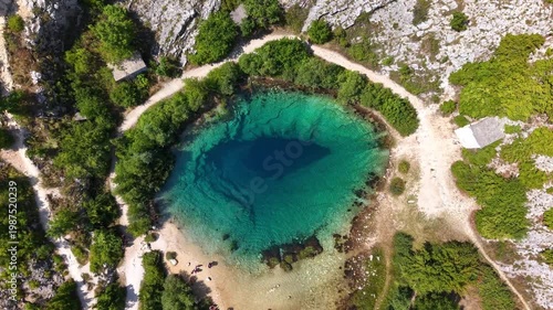 Aerial top-down view of the Eye of the Earth, Cetina River Spring in Croatia, turquoise karst spring water footage