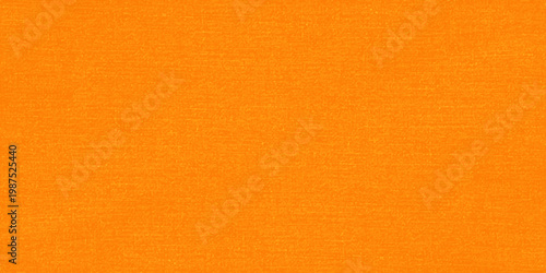 Aged orange paper and linen fabric material create a rough vintage textile texture with a grunge pattern on a blank surface backdrop