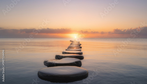 Stepping stones cross a calm water surface at sunset. A serene pathway leads toward the horizon as the sun sets over the still ocean, symbolizing a peaceful journey ahead towards a new dawn.