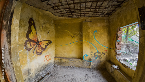 Obraz na płótnie Abandoned ashram near Rishikesh, Uttarakhand, featuring weathered walls covered with colorful graffiti and wall art, showcasing urban expression within a forgotten spiritual retreat