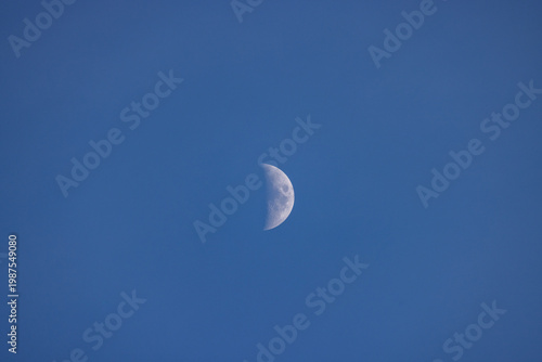Crescent moon against deep blue sky. Clear, detailed view of lunar surface. Moon phase shown accurately. No clouds or other objects visible