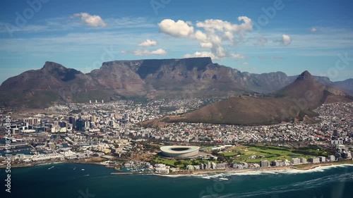 Aerial Cape Town Skyline With Table Mountain. Green Point Stadium And Atlantic Coast Stretch Below, Sunlit