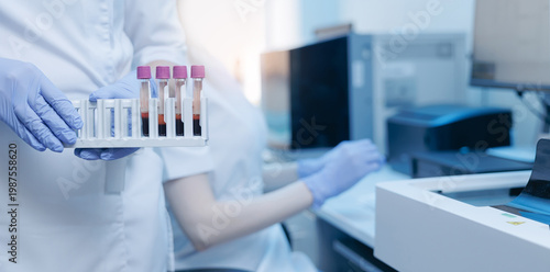 Bild auf Leinwand Laboratory technician holding blood sample tubes for clinical testing and diagno