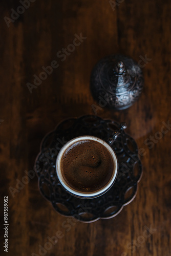 Wallpaper Mural Cup of Turkish coffee in traditional metal cup on old wooden background. Closeup, Selective focus. Top 
view, flat lay. Torontodigital.ca