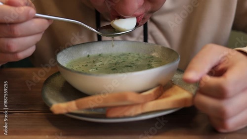 Close-up of a man eating noodle soup in a restaurant. Slow motion video.