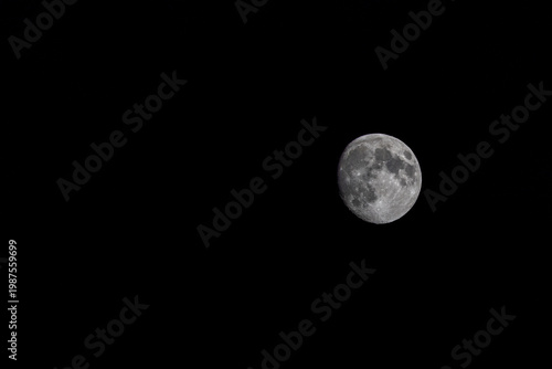 Near Full moon in sea of black