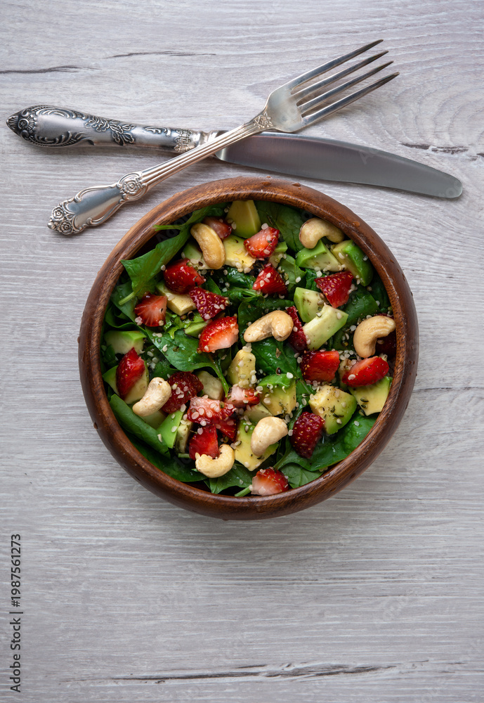 custom made wallpaper toronto digitalHealthy veggie salad with avocado, arugula, spinach, strawberries, cashews and seeds low carb, low calorie diet. Healthy eating, nutrition and diet concept. Top view, flat lay