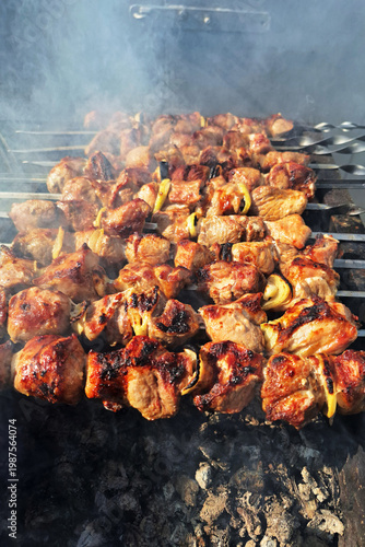 Grilled meat skewers on charcoal