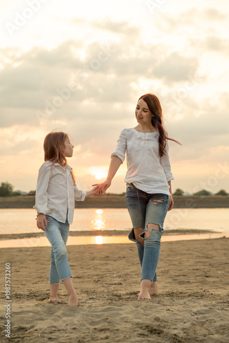 Mother and daughter walk outdoors. Woman and little girl spend time together on picnic. Mom and her child. Family concept. Selective focus.
