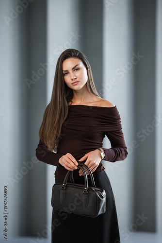 Wallpaper Mural Graceful Woman In Offshoulder Top Holding Sophisticated Accessory Near Architectural Elements Torontodigital.ca