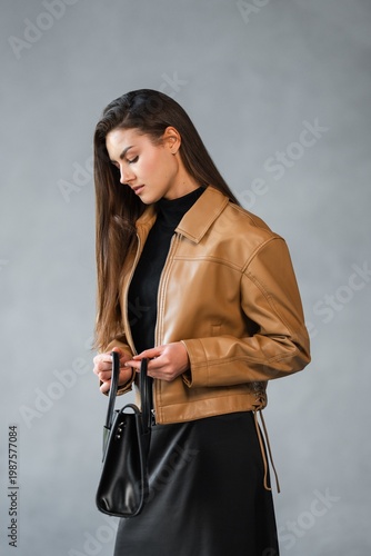 Wallpaper Mural Caucasian Woman Analyzes Clasp Of Handbag. Calm Woman Observes Features Of Fashionable Black Satchel Torontodigital.ca