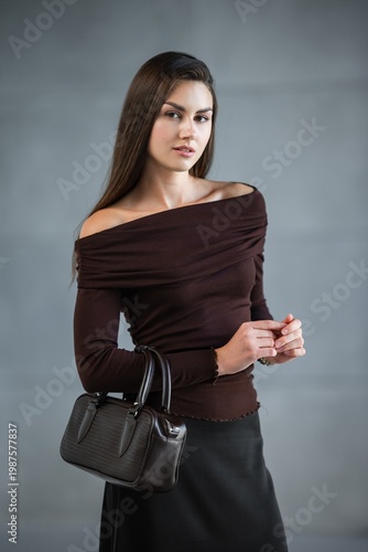 Wallpaper Mural Caucasian Woman Standing Smiling Gently, Offshoulder Brown Top And Black Skirt, Holding Black Handbag Torontodigital.ca