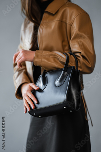 Wallpaper Mural Elegant Leather Accessory. Upscale Female Stylist Showcasing Smooth Leather Handbag With Skilled Touch Torontodigital.ca