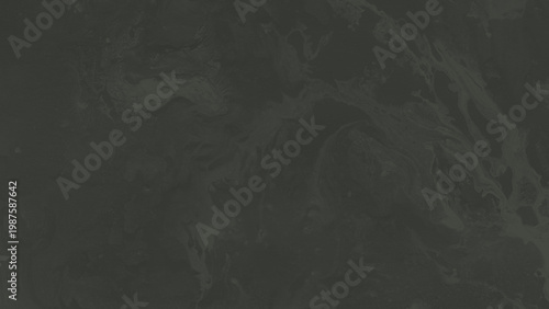 A dark gray marble texture featuring subtle wavy patterns and unique organic flowing stone veins