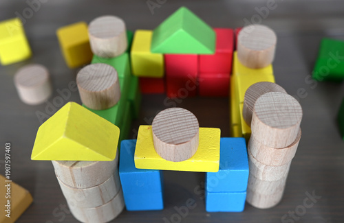 A high angle view of wooden toy blocks forming a castle 