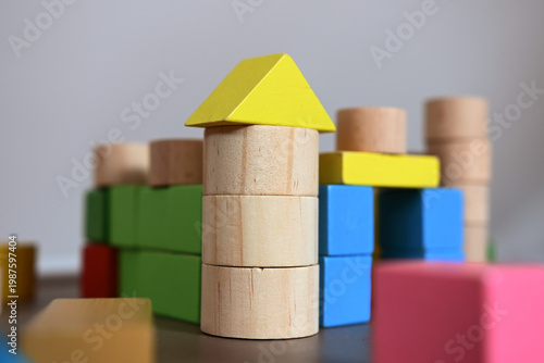 A close-up of wooden toy blocks forming a castle. 