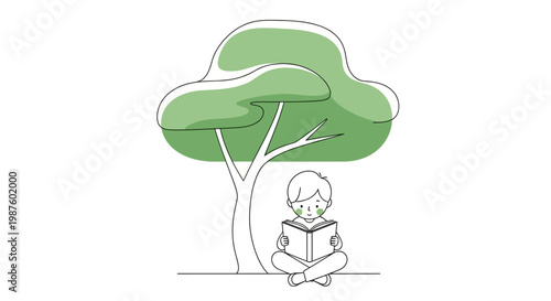 Boy reading book under tree.